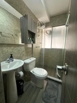 a bathroom with a toilet and a sink and a shower at 3BR AC LUXURY APARTMENT CLOSE TO THE AIRPORT Beach & THE HISTORIC CENTER in Cartagena de Indias