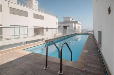 a swimming pool on the side of a building at 3BR AC LUXURY APARTMENT CLOSE TO THE AIRPORT Beach & THE HISTORIC CENTER in Cartagena de Indias