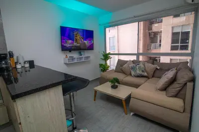 a living room with a couch and a table at 3BR AC LUXURY APARTMENT CLOSE TO THE AIRPORT Beach & THE HISTORIC CENTER in Cartagena de Indias