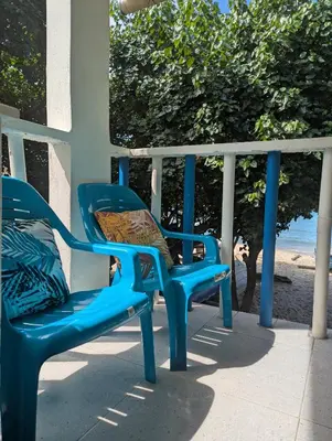 two blue chairs sitting on a porch near the beach at Casa Victoria in San Onofre