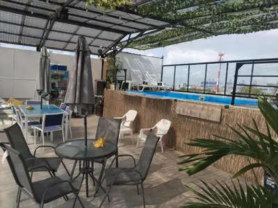 a patio with a table and chairs and a pool at Hostel HA1 in Cartagena de Indias