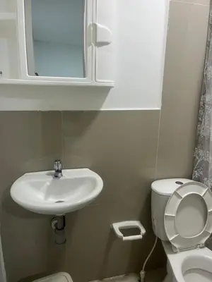 a bathroom with a sink and a toilet and a mirror at Hostel HA1 in Cartagena de Indias