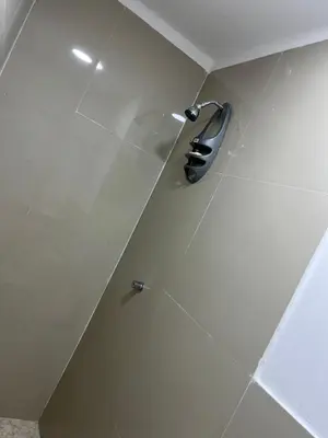a shower with a glass door in a bathroom at Hostel HA1 in Cartagena de Indias