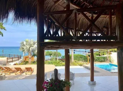 a view of a resort with a swimming pool and the ocean at La Mofa Beach House in Bocachica
