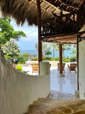 a porch of a resort with a view of the ocean at La Mofa Beach House in Bocachica