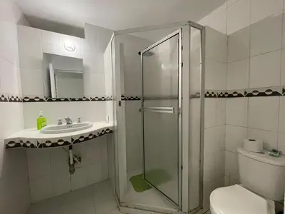 a bathroom with a shower and a toilet and a sink at Espectacular apartamento de 4 alcobas en el Laguito in Cartagena de Indias