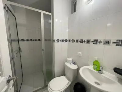 a bathroom with a shower and a toilet and a sink at Espectacular apartamento de 4 alcobas en el Laguito in Cartagena de Indias
