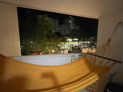 a large window with a hammock on the side of a building at Espectacular apartamento de 4 alcobas en el Laguito in Cartagena de Indias