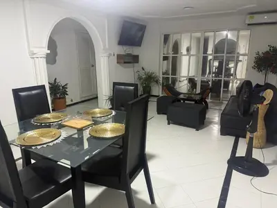 a living room with a glass table and chairs at Espectacular apartamento de 4 alcobas en el Laguito in Cartagena de Indias