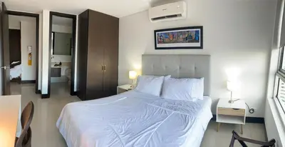 a bedroom with a large white bed in a room at Apto 2301 vista al mar Palmetto elíptic in Cartagena de Indias