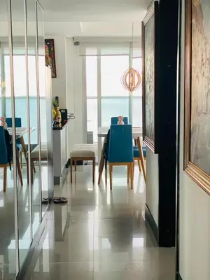 a living room with a table and chairs and the ocean at Apto 2301 vista al mar Palmetto elíptic in Cartagena de Indias