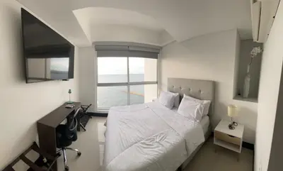 a small bedroom with a bed and a window at Apto 2301 vista al mar Palmetto elíptic in Cartagena de Indias