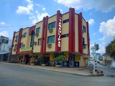 a large building with a sign on a street at Hotel Tamaulipas Mixteca in Sincelejo