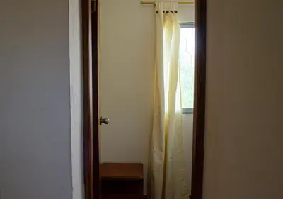 a door with a curtain in a room with a window at Alojamiento Familiar #4 - El mejor mar y playas in Puerto Viejo