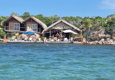 a resort on the water with chairs and umbrellas at Alojamiento Familiar #4 - El mejor mar y playas in Puerto Viejo