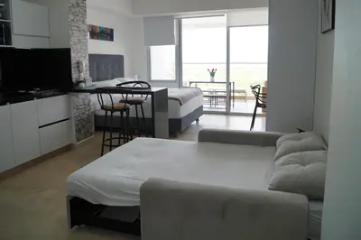 a living room with a couch and a table at Cartagena Aparta Suite Crespo Aeropuerto in Cartagena de Indias