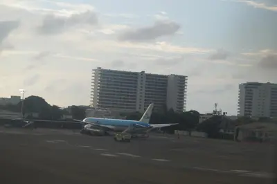 an airplane is parked on the runway at an airport at Cartagena Aparta Suite Crespo Aeropuerto in Cartagena de Indias
