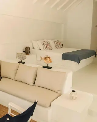 a white room with a bed and a couch at Casa Rosario in Isla Grande