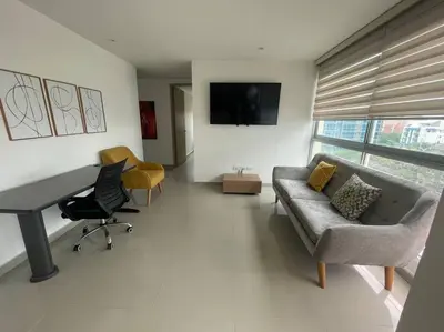 a living room with a couch and a desk at Confort en el norte de la ciudad in Ciudad Jardín