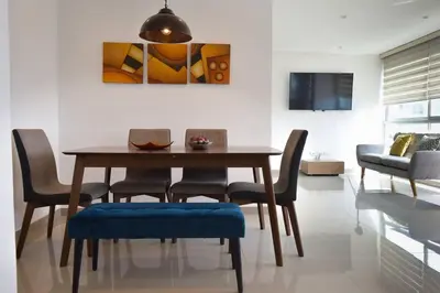 a dining room with a wooden table and chairs at Confort en el norte de la ciudad in Ciudad Jardín