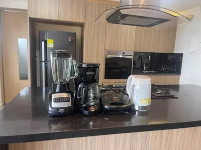 a kitchen counter with a blender and appliances on it at Confort en el norte de la ciudad in Ciudad Jardín