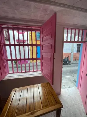 a room with a bench in front of some windows at Beautiful house en el centro in Cartagena de Indias