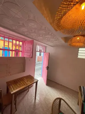 a room with a table and a pink door at Beautiful house en el centro in Cartagena de Indias