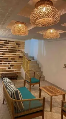 a room with chairs and a staircase with two lights at Beautiful house en el centro in Cartagena de Indias