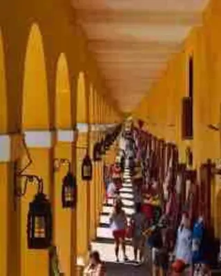 a group of people walking down a aisle in a store at Beautiful house en el centro in Cartagena de Indias