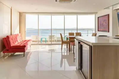 a living room with a red chair and a table at Playa Mar in Cartagena de Indias