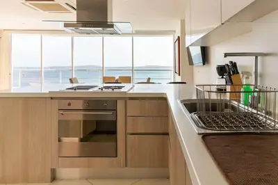 a kitchen with a stove and a sink and a counter at Playa Mar in Cartagena de Indias