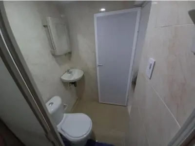 a small bathroom with a toilet and a sink at Hostal Doña Betty 2 in Cartagena de Indias