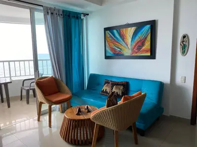 a living room with a blue couch and a table at Apartamento Palmetto en Cartagena Vista al mar 702 in Cartagena de Indias