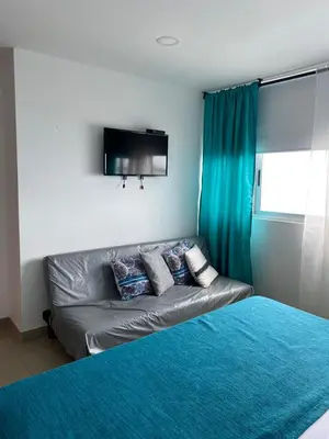 a couch with pillows on it in a bedroom at Apartamento Palmetto en Cartagena Vista al mar 702 in Cartagena de Indias