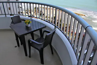 a table and chairs on a balcony with the beach at Apartamento Palmetto en Cartagena Vista al mar 702 in Cartagena de Indias