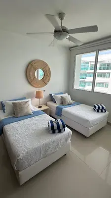 a bedroom with two beds and a ceiling fan at Apartamento con salida y vista a la playa in Cartagena de Indias