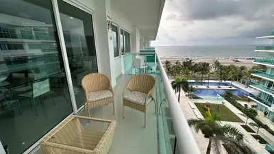 a balcony with chairs and a view of the beach at Apartamento con salida y vista a la playa in Cartagena de Indias