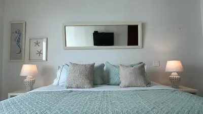 a bedroom with a bed with a tv on the wall at Apartamento con salida y vista a la playa in Cartagena de Indias