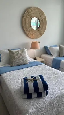 a bedroom with a bed with a mirror on the wall at Apartamento con salida y vista a la playa in Cartagena de Indias