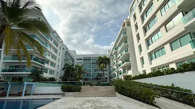 a view of a building with palm trees and stairs at Apartamento con salida y vista a la playa in Cartagena de Indias