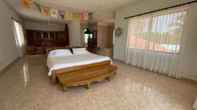 a bedroom with a bed and a large window at Casa frente a la playa, San Antero Cordoba in San Antero