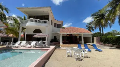 a house with chairs and a table and a swimming pool at Casa frente a la playa, San Antero Cordoba in San Antero