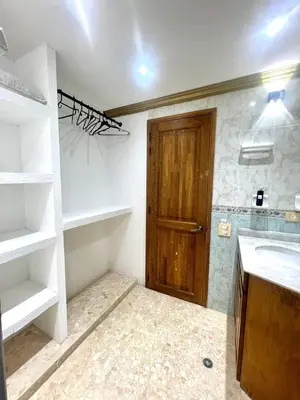 a bathroom with a sink and a wooden door at Private House - 4 Pisos - 100 Mts de la playa in Cartagena de Indias