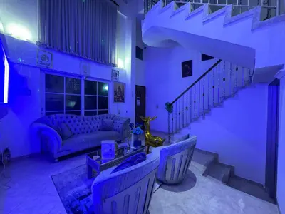 a purple living room with a couch and a staircase at Private House - 4 Pisos - 100 Mts de la playa in Cartagena de Indias