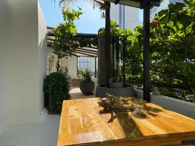 a wooden table on a balcony with plants at Apartamento Loft in Cartagena de Indias