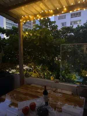 a patio with a table and a window with lights at Apartamento Loft in Cartagena de Indias