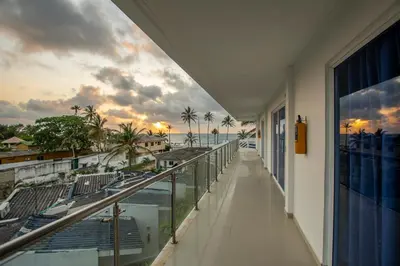 a balcony of a building with a view of the ocean at Hotel Be Real in Coveñitas
