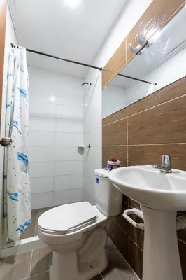 a bathroom with a toilet and a sink at Hotel Be Real in Coveñitas