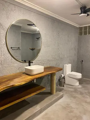 a bathroom with a mirror and a sink and a toilet at Casa Piedra Barranquilla in Barranquilla