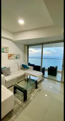 a living room with a white couch and a glass table at Palmetto Eliptic in Cartagena de Indias